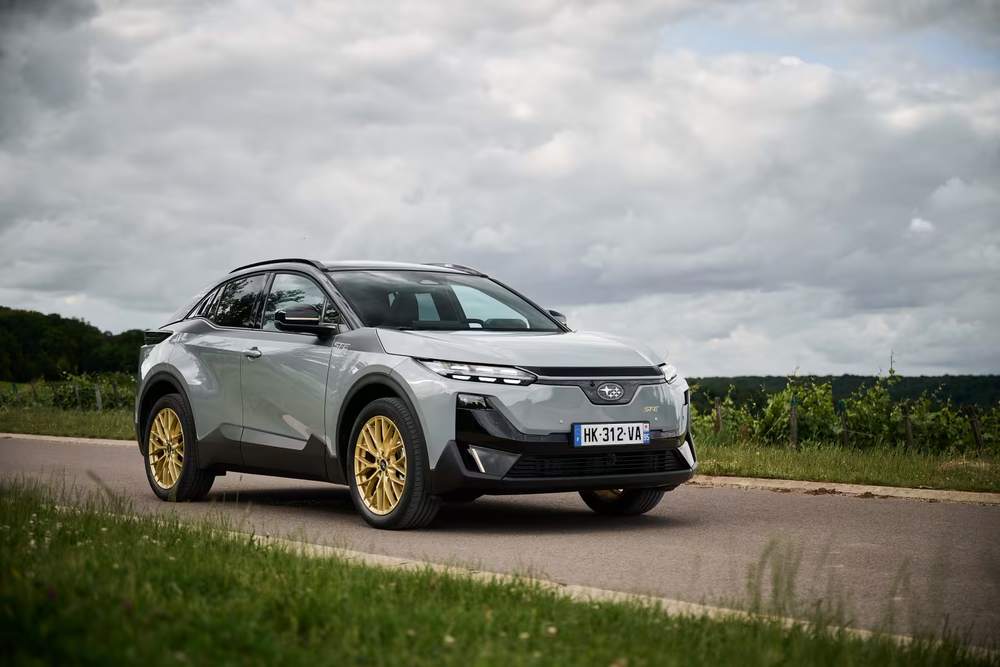 Grey Subaru Uncharted with gold wheels, ST-E pack, on a country road