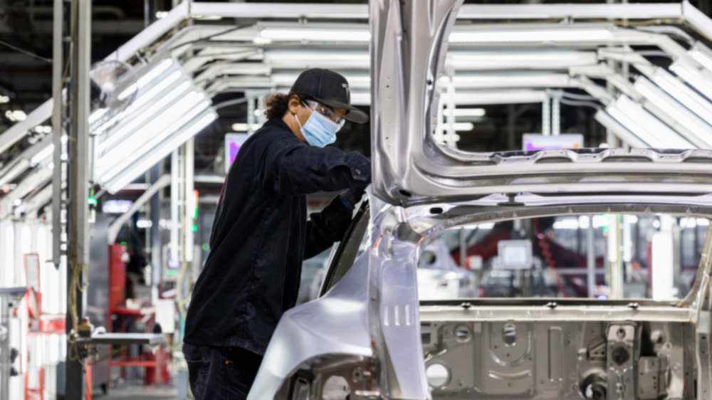 Tesla employee working on the Giga Berlin assembly line