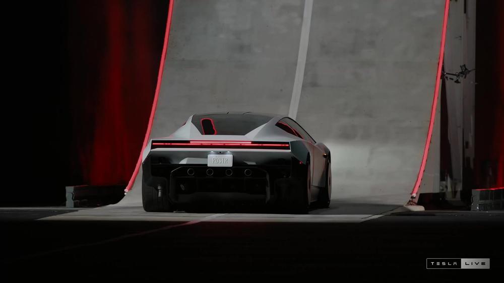White Tesla Roadster seen from behind at the base of the curved ramp in Tesla’s livestream
