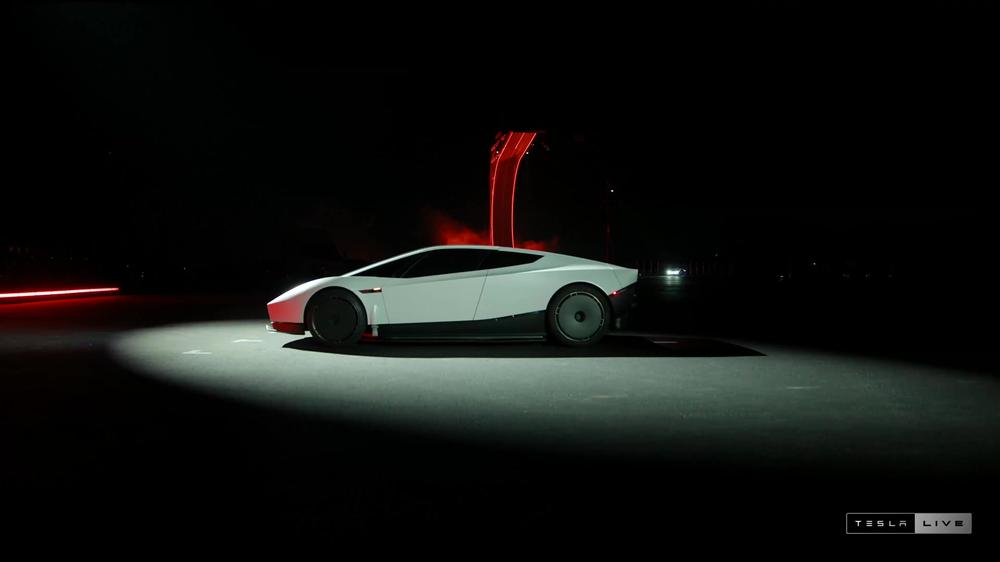 Side profile of the white Tesla Roadster under a spotlight in Tesla's livestream