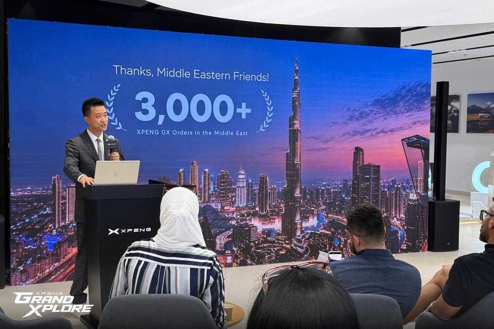 XPENG presentation in the Middle East, with the message 'Thanks, Middle Eastern Friends! 3,000+' on screen