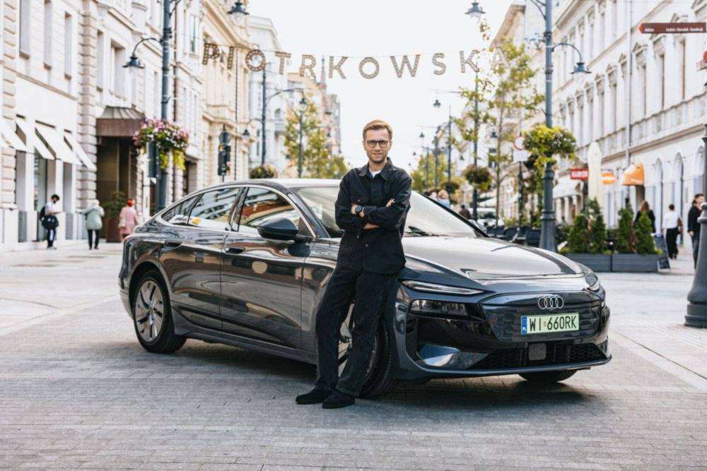 Miko Marczyk next to the Audi A6 Sportback e-tron performance he used to set the Guinness World Record