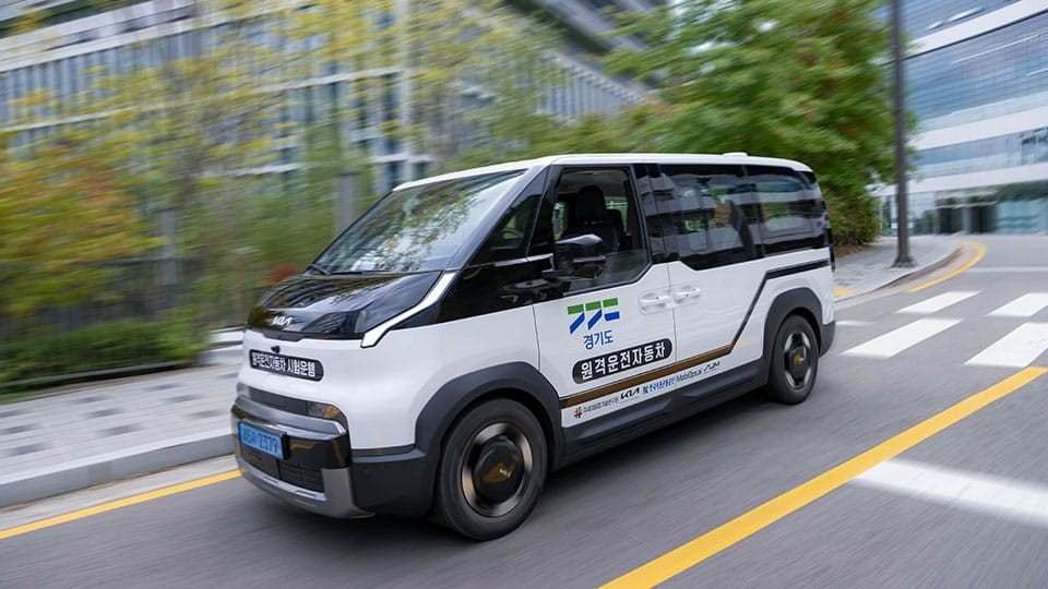 White Kia PV5 in the pilot service livery on a street in Pangyo