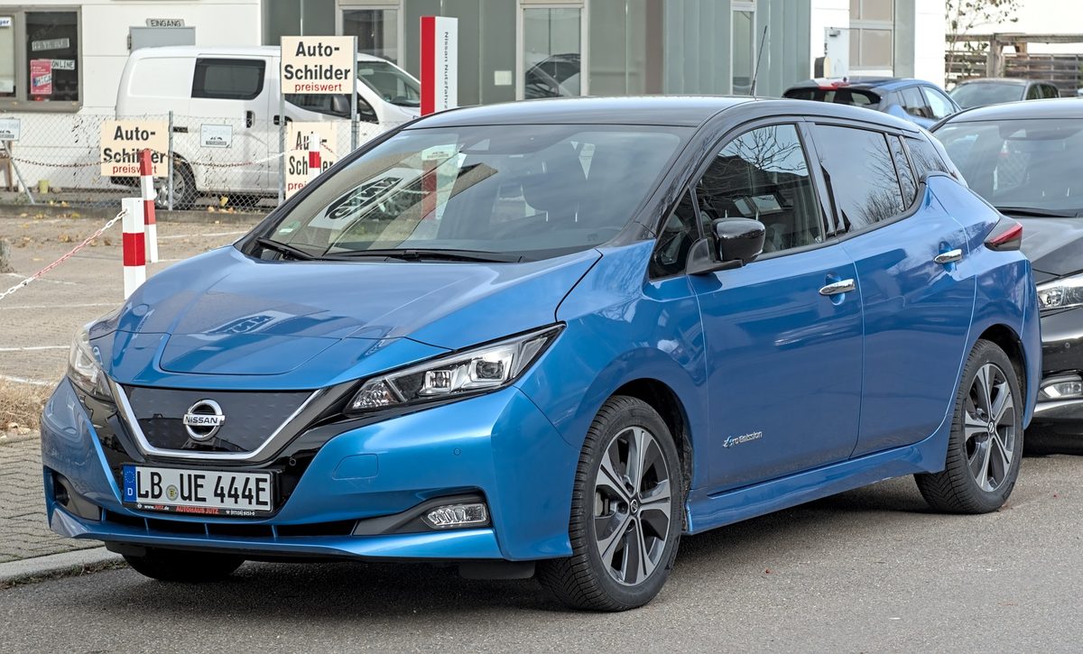 Blue second-generation Nissan Leaf parked outside a license-plate shop in Gerlingen, Germany