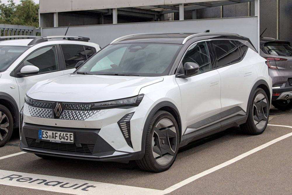 White Renault Scenic E-Tech parked outside a Renault dealership