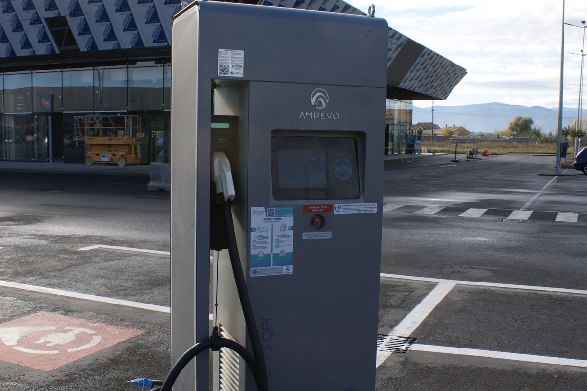 AMPEVO charging station with a screen and charging cable, in a shopping-centre car park in Sibiu, Romania