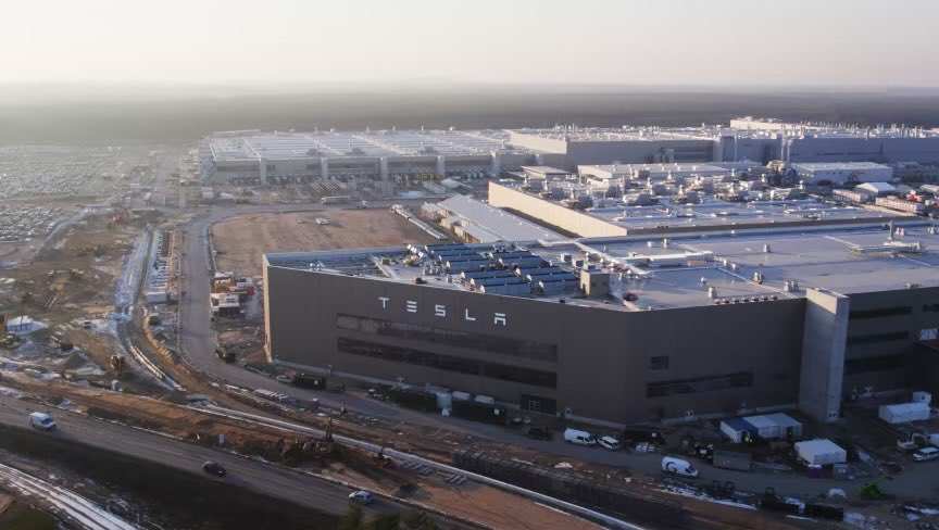 Aerial view of Tesla Giga Berlin in Grünheide, with the Tesla logo on the hall facade