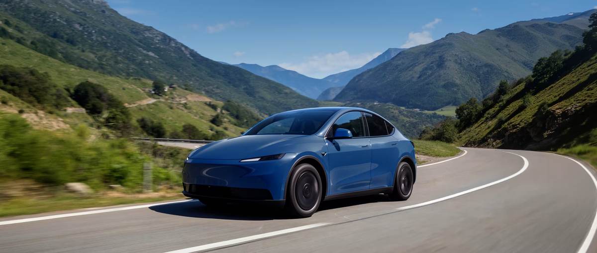 Blue Tesla Model Y Standard on a mountain road