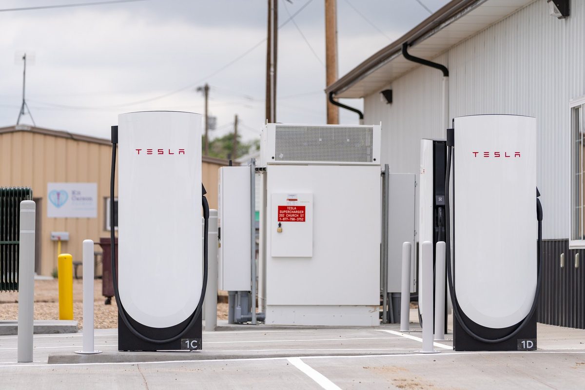 Two Tesla V4 Supercharger posts with hanging cables at a station in Colorado, USA
